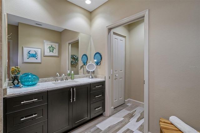 4951 Bacopa Ln S Unit 801, Saint Petersburg, FL 33715 - bathroom with visible vents, wood finished floors, and vanity