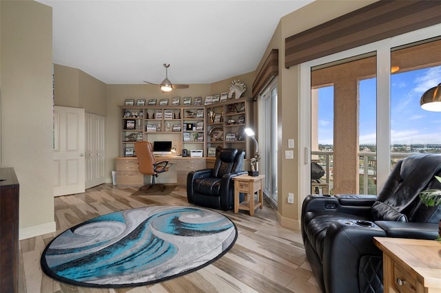 4951 Bacopa Ln S Unit 801, Saint Petersburg, FL 33715 - interior space with baseboards, built in desk, light wood finished floors, and ceiling fan