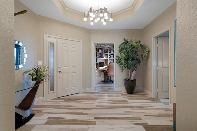 4951 Bacopa Ln S Unit 801, Saint Petersburg, FL 33715 - foyer featuring ornamental molding, a tray ceiling, light wood-style floors, baseboards, and a chandelier