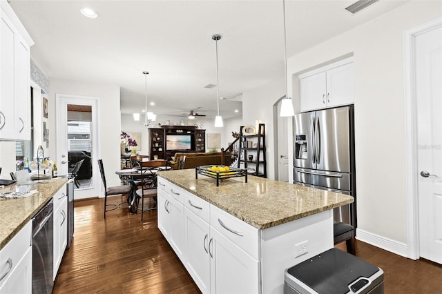 kitchen featuring visible vents, white cabinets, a kitchen island, dark wood-style flooring, and stainless steel appliances