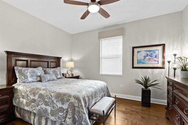 bedroom featuring ceiling fan, baseboards, and dark wood-style flooring