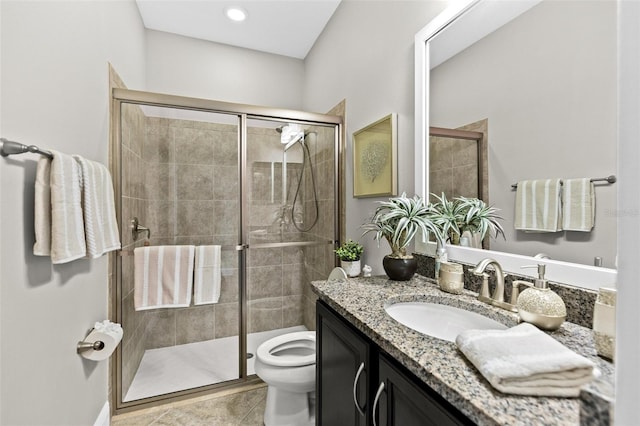 full bathroom featuring a stall shower, vanity, and toilet