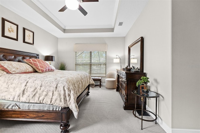 bedroom featuring carpet flooring, a raised ceiling, visible vents, and baseboards