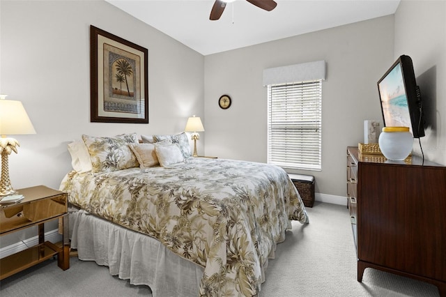 bedroom featuring baseboards, a ceiling fan, and light colored carpet