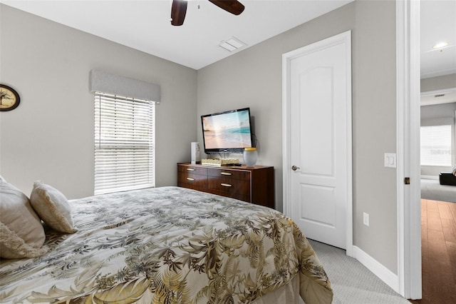 bedroom featuring visible vents, ceiling fan, light carpet, and baseboards