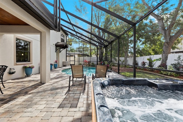 view of patio / terrace featuring glass enclosure, central AC unit, a fenced backyard, a fenced in pool, and a hot tub