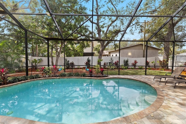 view of swimming pool featuring a patio area, a fenced backyard, and a lanai