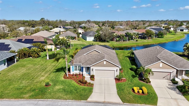 birds eye view of property featuring a water view and a residential view