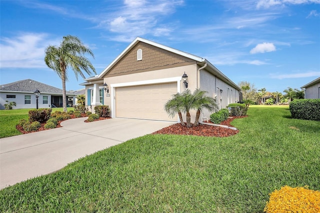 view of front of property with driveway, an attached garage, a front yard, and stucco siding