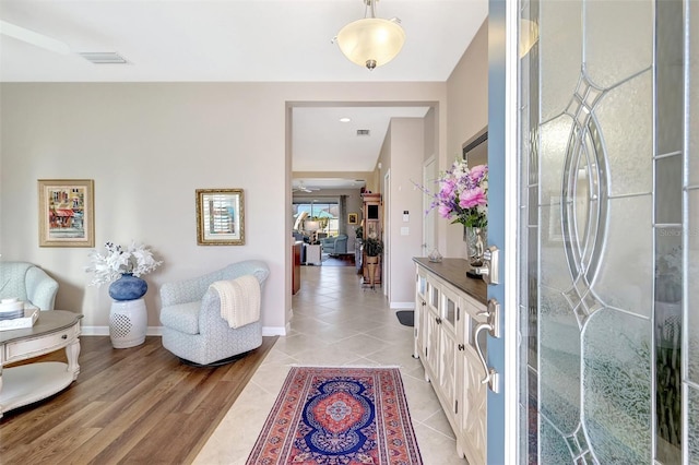 foyer entrance featuring visible vents, baseboards, and light tile patterned flooring