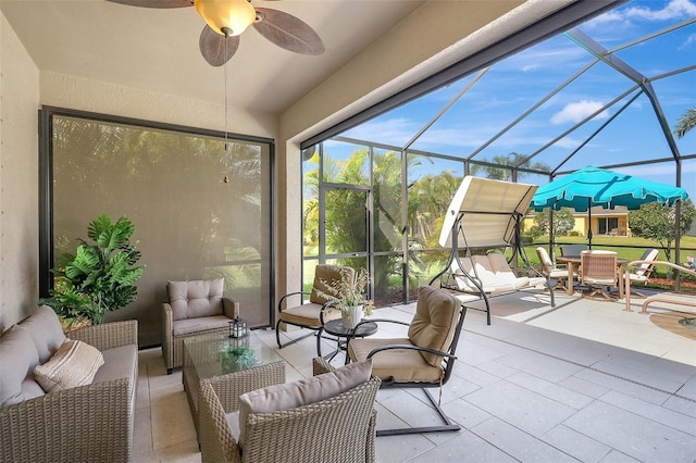 sunroom featuring a ceiling fan