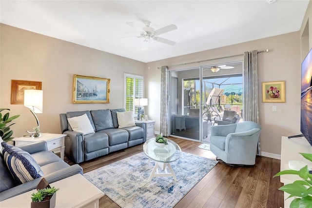 living area featuring ceiling fan, wood finished floors, and baseboards