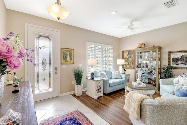 foyer with baseboards, visible vents, a ceiling fan, and light tile patterned flooring