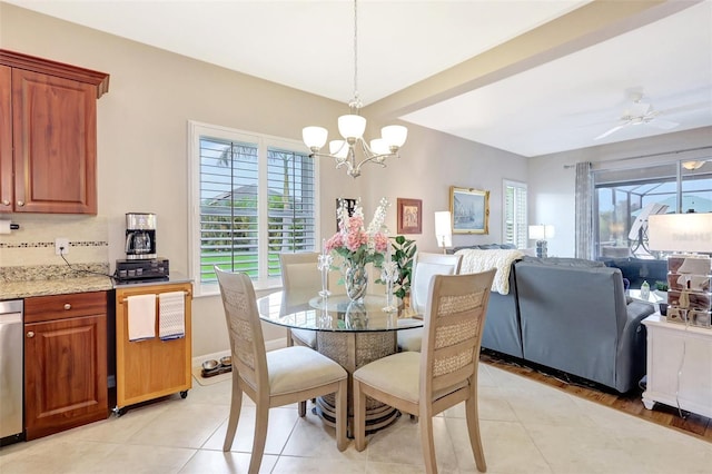 dining room with light tile patterned flooring, baseboards, and ceiling fan with notable chandelier