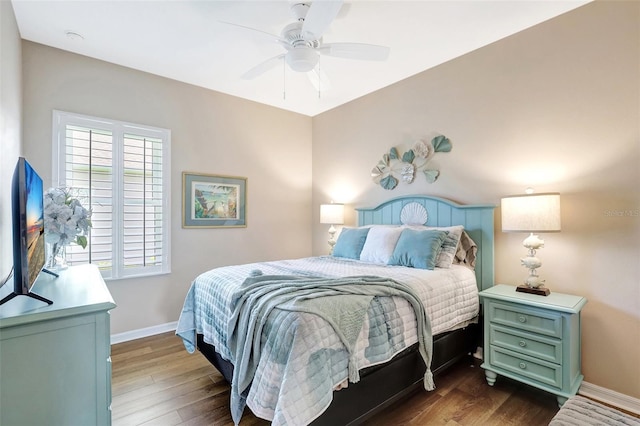 bedroom with dark wood-style floors, ceiling fan, and baseboards