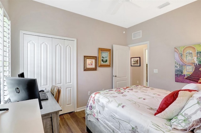 bedroom with a ceiling fan, a closet, visible vents, and wood finished floors