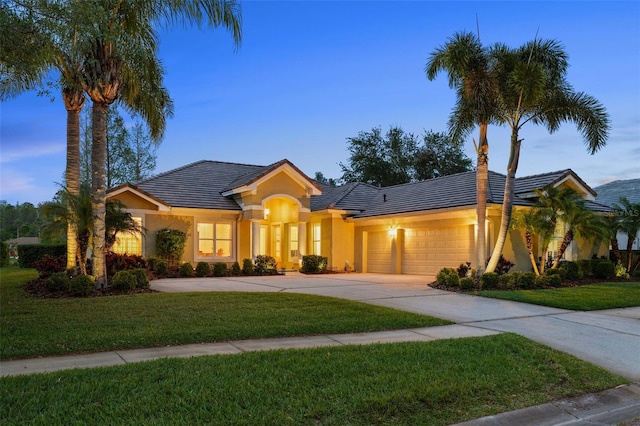 11815 Marblehead Dr, Tampa, FL 33626 - view of front facade featuring a front lawn, stucco siding, an attached garage, and concrete driveway