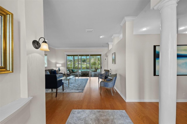 11815 Marblehead Dr, Tampa, FL 33626 - living area featuring ornamental molding, wood finished floors, and decorative columns