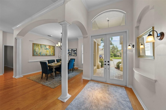 11815 Marblehead Dr, Tampa, FL 33626 - foyer entrance featuring french doors, arched walkways, ornate columns, and wood finished floors