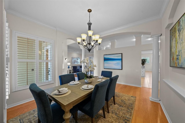 11815 Marblehead Dr, Tampa, FL 33626 - dining space featuring decorative columns, ornamental molding, baseboards, a chandelier, and light wood-style floors