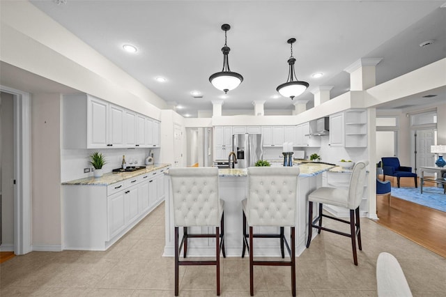 11815 Marblehead Dr, Tampa, FL 33626 - kitchen with tasteful backsplash, stainless steel fridge with ice dispenser, light tile patterned flooring, wall chimney range hood, and white cabinets