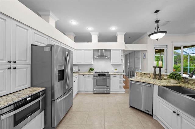 11815 Marblehead Dr, Tampa, FL 33626 - kitchen featuring crown molding, white cabinetry, appliances with stainless steel finishes, light tile patterned floors, and wall chimney range hood