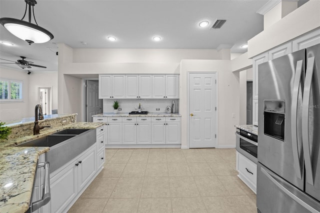 11815 Marblehead Dr, Tampa, FL 33626 - kitchen with light tile patterned flooring, ceiling fan, white cabinetry, a sink, and stainless steel refrigerator with ice dispenser
