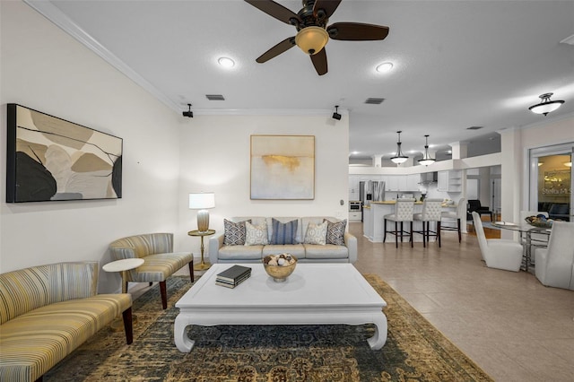 11815 Marblehead Dr, Tampa, FL 33626 - living room with light tile patterned floors, a ceiling fan, visible vents, and crown molding