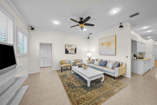 11815 Marblehead Dr, Tampa, FL 33626 - living area featuring light tile patterned flooring, visible vents, baseboards, ornamental molding, and ceiling fan