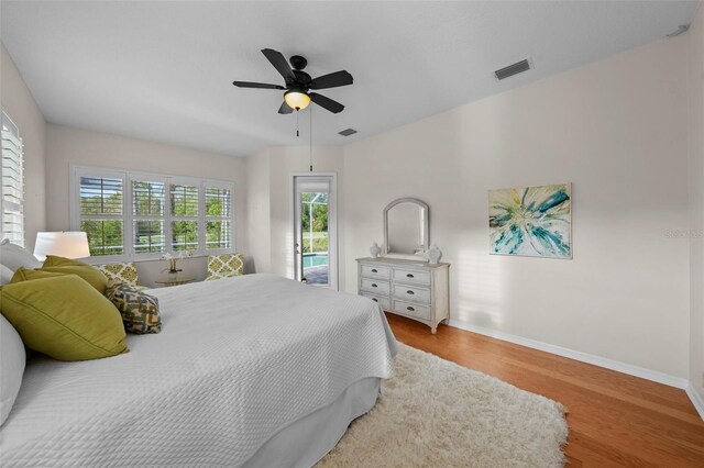 11815 Marblehead Dr, Tampa, FL 33626 - bedroom with access to exterior, wood finished floors, baseboards, and visible vents