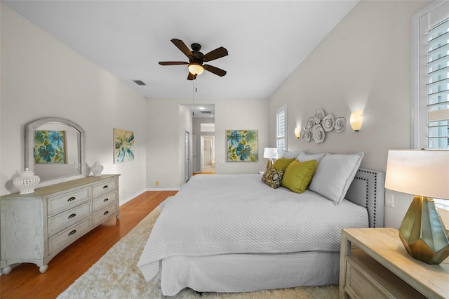 11815 Marblehead Dr, Tampa, FL 33626 - bedroom with baseboards, visible vents, light wood-style floors, and a ceiling fan