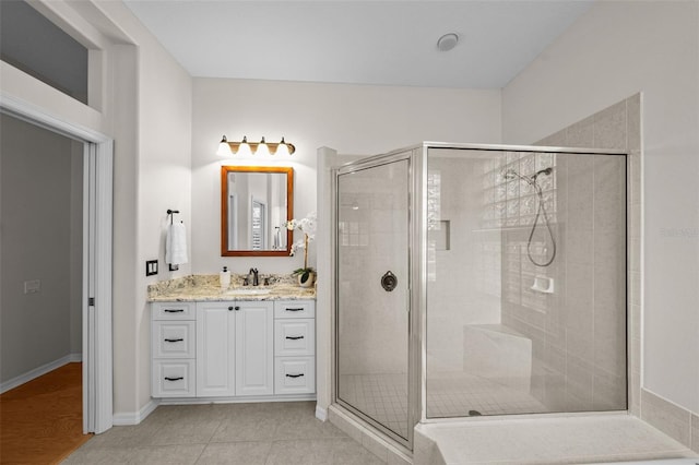 11815 Marblehead Dr, Tampa, FL 33626 - bathroom featuring baseboards, a stall shower, tile patterned flooring, and vanity
