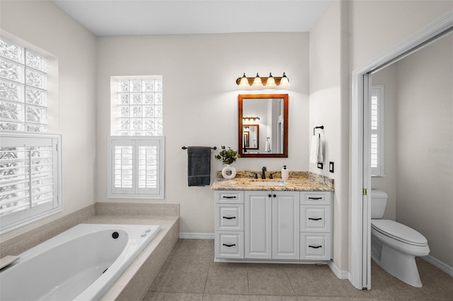 11815 Marblehead Dr, Tampa, FL 33626 - bathroom with tile patterned flooring, vanity, toilet, baseboards, and a garden tub