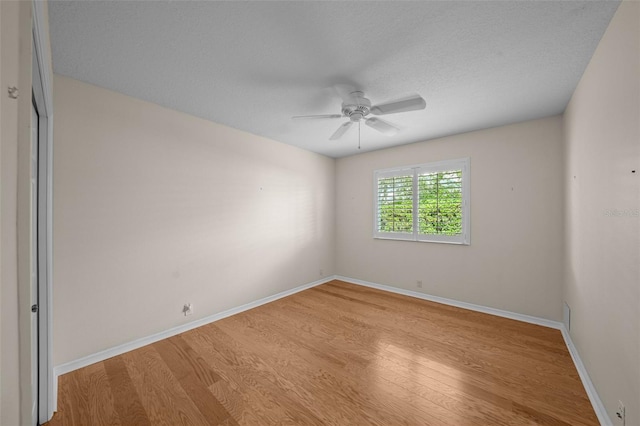 11815 Marblehead Dr, Tampa, FL 33626 - empty room with baseboards, a textured ceiling, wood finished floors, and a ceiling fan
