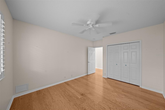 11815 Marblehead Dr, Tampa, FL 33626 - unfurnished bedroom with baseboards, light wood-type flooring, visible vents, and a closet