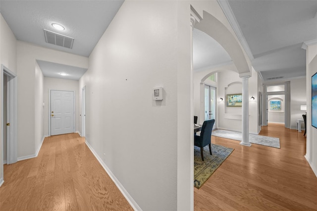 11815 Marblehead Dr, Tampa, FL 33626 - hallway featuring decorative columns, crown molding, wood finished floors, visible vents, and arched walkways