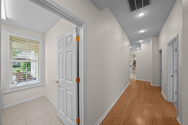 11815 Marblehead Dr, Tampa, FL 33626 - corridor featuring baseboards, visible vents, and a textured ceiling