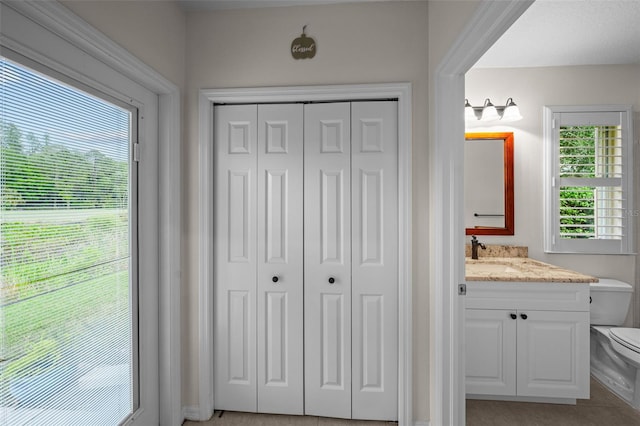 11815 Marblehead Dr, Tampa, FL 33626 - bathroom featuring a closet, toilet, and vanity