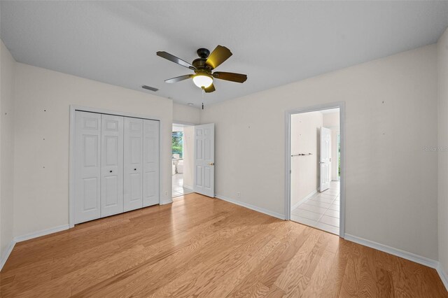 11815 Marblehead Dr, Tampa, FL 33626 - unfurnished bedroom with a closet, visible vents, baseboards, ceiling fan, and light wood-type flooring