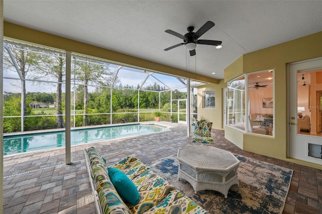 11815 Marblehead Dr, Tampa, FL 33626 - outdoor pool with a ceiling fan, glass enclosure, and a patio