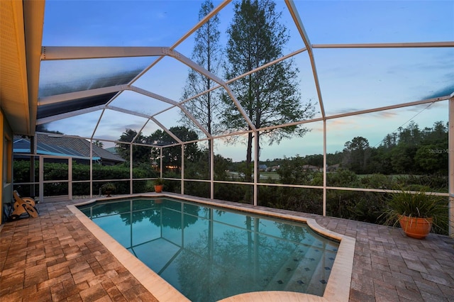 11815 Marblehead Dr, Tampa, FL 33626 - pool at dusk with a lanai, an outdoor pool, and a patio area