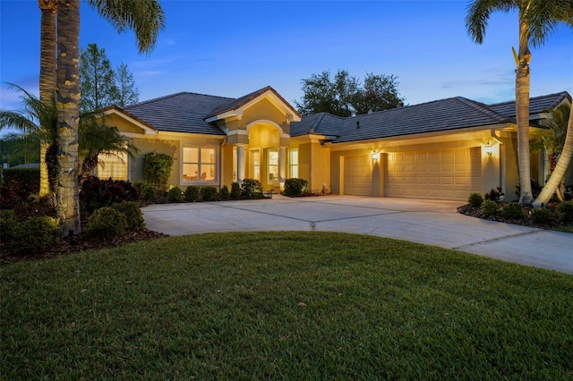 11815 Marblehead Dr, Tampa, FL 33626 - view of front facade featuring a tiled roof, stucco siding, concrete driveway, and a garage