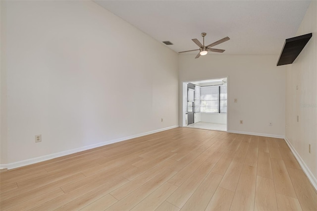 spare room with visible vents, baseboards, vaulted ceiling, a ceiling fan, and light wood-type flooring