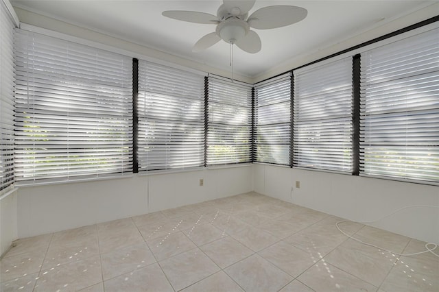 unfurnished sunroom with ceiling fan