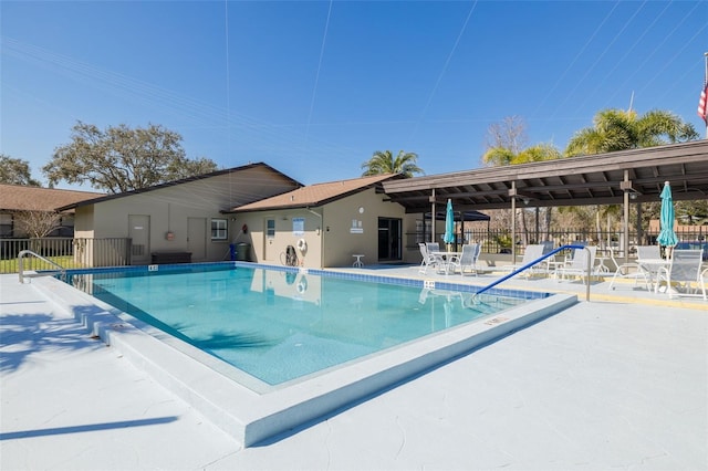 pool featuring a patio and fence