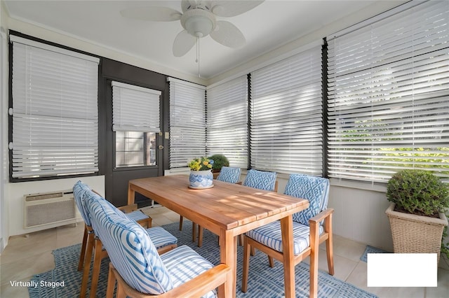 dining space with a ceiling fan, a sunroom, a wall mounted air conditioner, and light tile patterned floors