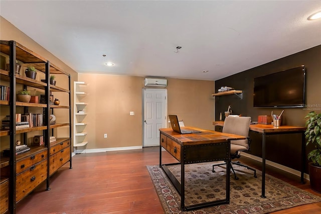 office featuring recessed lighting, wood finished floors, baseboards, and a wall mounted AC