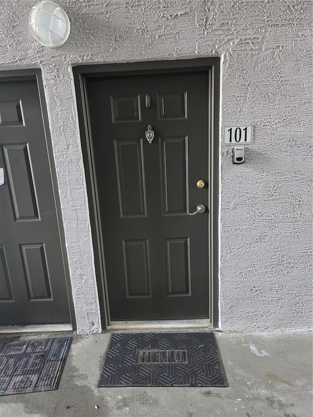 entrance to property with stucco siding