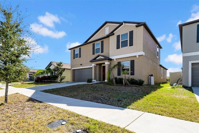 traditional-style home with a front yard, driveway, an attached garage, and stucco siding