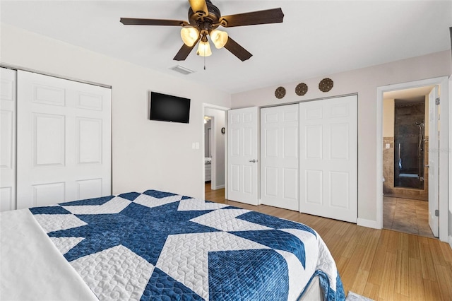 bedroom featuring light wood-type flooring, a ceiling fan, visible vents, and a closet
